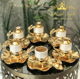 Luxurious Turkish coffee set with golden lids.