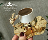 Luxurious Turkish coffee set with golden lids.